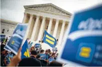  ?? FILE PHOTO BY TOM BRENNER/THE NEW YORK TIMES ?? Protesters with Human Rights Campaign flags outside the Supreme Court following the court’s ruling in the case of a Colorado baker who refused to create a custom wedding cake for a gay couple. A new justice retirement puts the balance of the court —...