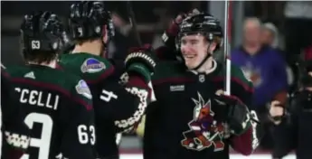  ?? (AP PHOTO/ROSS D. FRANKLIN) ?? Arizona Coyotes' Josh Doan, right, smiles as he celebrates his two-goal NHL debut with Juuso Valimaki (4) and Matias Maccelli (63), after the team's 6-2 win against the Columbus Blue Jackets on Tuesday night in Tempe, Ariz.