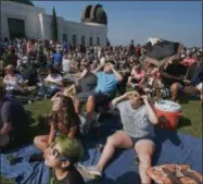  ?? THE ASSOCIATED PRESS ?? The Tinoco family from Cyprus, Calif., gather to watch the partial eclipse at the Griffith Observator­y in Los Angeles on Monday, Aug. 21, 2017.