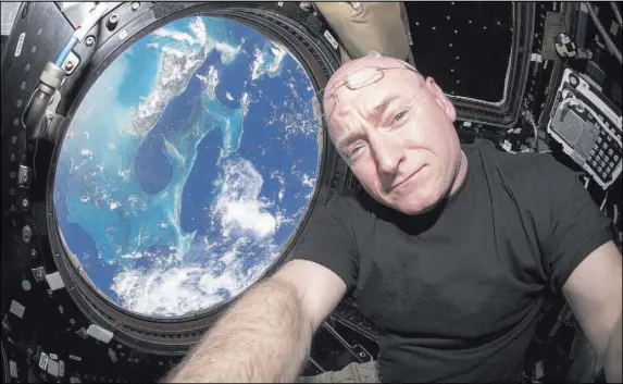  ?? NASA ?? A photo that astronaut Scott Kelly took of himself inside the cupola of the Internatio­nal Space Station in July 2015.