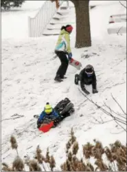  ?? GENE WALSH — DIGITAL FIRST MEDIA ?? Kids sled down a hill in their developmen­t in Trappe on Thursday.