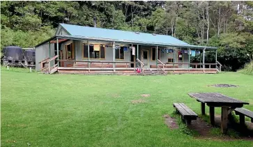  ??  ?? Most hikers spend the afternoon and evening outdoors at Waiopaoa Hut, despite the sandflies.