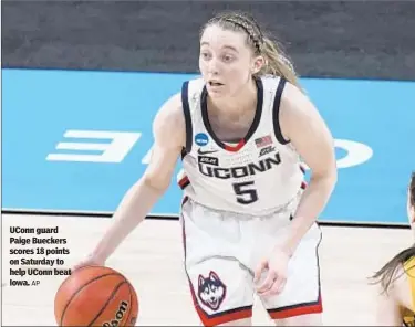  ?? AP ?? UConn guard Paige Bueckers scores 18 points on Saturday to help UConn beat Iowa.