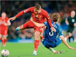  ?? AP ?? Liverpool’s Roberto Firmino (left) is tackled by Chelsea’s Marcos Alonso during their English FA Cup match at the Stamford Bridge in London on Tuesday. —