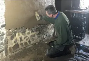  ??  ?? Below: Alan is taking on his own heritage renovation project – here he is applying clay plaster to an internal wall