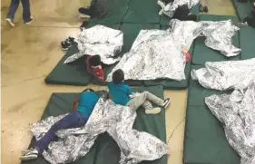  ?? U.S. CUSTOMS AND BORDER PROTECTION’S RIO GRANDE VALLEY SECTOR VIA AP ?? People who’ve been taken into custody related to cases of illegal entry into the United States rest in one of the cages at a facility in McAllen, Texas, on Sunday.