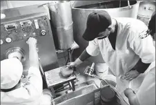  ?? ?? Workers package ice cream at the Cid Ice Cream factory run by Cuban entreprene­urs Henry and Yendri Garcia, in Bauta, Cuba, December 3, 2021.