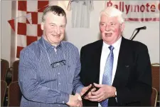  ??  ?? Joe Taaffe makes a presentati­on to Fr Dan O’Mahony who was on the Management team of the 1993 Championsh­ip winners.