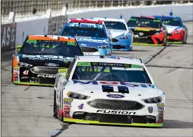  ?? AP/LARRY PAPKE ?? Kevin Harvick races into Turn 1 during Sunday’s NASCAR Cup race at Texas Motor Speedway in Fort Worth. Harvick rocketed past polesitter Ryan Blaney in overtime to win.