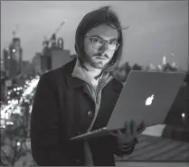  ?? Chris Goodney/Bloomberg ?? "There's definitely a level of stress that comes with being independen­t that's absent at Google, but I like that," says freelance coder James Knight, a former Google employee, shown on a rooftop in Brooklyn this month.