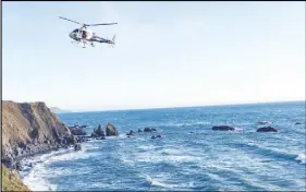  ?? CALIFORNIA HIGHWAY PATROL VIA AP ?? A helicopter hovers over steep coastal cliffs near Mendocino, Calif., where a vehicle plunged off a cliff along Highway 1