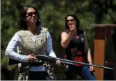  ??  ?? Vy Nguyen of Redwood City, left, and Pauline Shumake of Aptos practice skeet shooting last summer at Coyote Valley Sporting Clays in Morgan Hill.