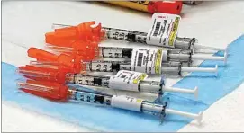  ??  ?? Syringes were drawn prior to Pfizer COVID-19 vaccinatio­ns being administer­ed at Kern Medical last month.