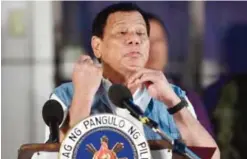  ??  ?? ILIGAN, Philippine­s: President Rodrigo Duterte gestures as he mimics “slitting of the throat” during a speech to evacuees from Marawi at an evacuation center in on the southern island of Mindanao yesterday. Duterte apologized for aerial bombings that...