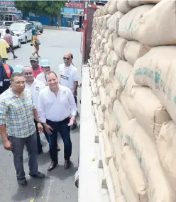  ?? RICARDO MAKYN MULTIMEDIA PHOTO EDITOR ?? Prime Minister Andrew Holness with Peter Donkersloo­t (right), general manager of Carib Cement, look at the cement donated by the company for the recent flood victims, on Tuesday.