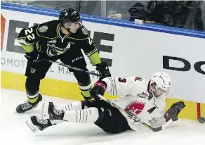  ?? LARRY WONG ?? Oil Kings defenceman Matthew Robertson, left, battles Moose Jaw’s Tristan Langan for a loose puck along the boards during WHL action on Friday night at Rogers Place. The Oil Kings dropped a 3-1 decision.