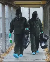  ?? PHOTO COURTESY MENDOCINO COUNTY JAIL ?? MCSO Personnel in Hazmat suits after cleaning the inmate’s contaminat­ed cell.