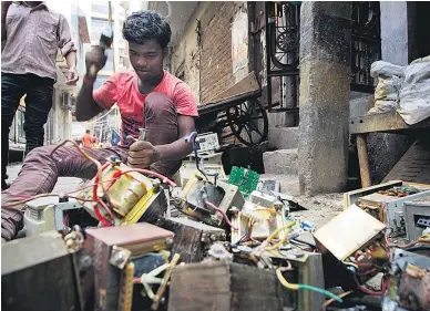  ?? Picture / Bloomberg ?? Breaking up used computers on the streets of New Delhi, India.