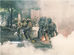  ?? NYT ?? Federal law enforcemen­t agents disperse crowds in Portland, Oregon on Saturday. Protesters have been in the streets for more than 50 consecutiv­e days.