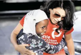  ?? Elaine Thompson / Associated Press ?? First-grade student Halima Said, 6, meets her teacher, Amber Simonton, for the first time on the picket line where Simonton joined other teachers Wednesday morning in Seattle.