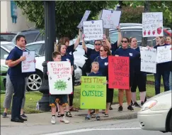  ?? Ernest A. Brown photo ?? Members of the Woonsocket Teachers Guild and their supporters hold signs during an informatio­nal picket in Market Square in Woonsocket Friday. The picket was intended to coincide with a fundraiser for Woonsocket Mayor Lisa Baldelli-Hunt at River Falls Restaurant just across the street.