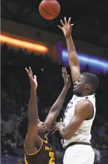  ?? Photos by Ben Margot / Associated Press ?? Cal’s Kingsley Okoroh, a 7-foot-1 senior, shoots over Arizona State’s Romello White during the first half.