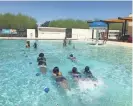  ?? ADRIAN MARSH/THE REPUBLIC ?? Swimmers show off at the Maryvale Family YMCA in Phoenix on Tuesday.