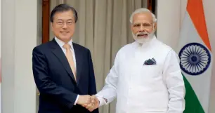  ?? — AP ?? Moon Jae-in shakes hands with Narendra Modi before their meeting in New Delhi on Tuesday.