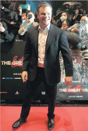  ?? — THE ASSOCIATED PRESS FILES ?? Matt Damon smiles in front of fans as he arrives at a red carpet event for the movie The Great Wall in Beijing earlier this month. Damon has had to defend being cast in the China-Hollywood production.