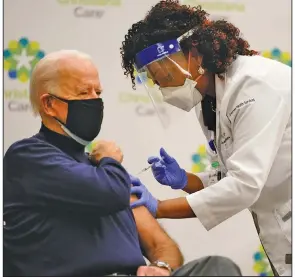  ?? (AP/Carolyn Kaster) ?? President-elect Joe Biden receives his first dose of the coronaviru­s vaccine from nurse practition­er Tabe Mase on Monday at Christiana Hospital in Newark, Del.