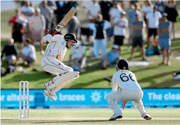  ?? AP ?? Black Caps batsman Mitchell Santner fends at a short-pitched ball from Ben Stokes during the first test at Mt Maunganui yesterday. The fielder is England captain Joe Root.