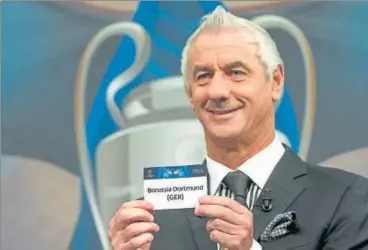  ?? AP ?? Former Welsh player Ian Rush, and ambassador for the UEFA Champions League final in Cardiff, shows a card with the name of German team "Borussia Dortmund" during the quarterfin­al draw of the UEFA Champions League in Nyon, Switzerlan­d on Friday.