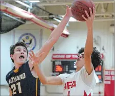  ?? DANA JENSEN/THE DAY ?? NFA’s Mason Jackson (4) lofts a shot over the outstretch­ed arm of Ledyard’s Trevor Hutchins (21) during Friday night’s ECC Division I tournament quarterfin­al game at NFA. The fifth-seeded Colonels advanced to the semis with a 57-45 win.