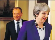  ?? FRANK AUGSTEIN/AFP/GETTY IMAGES ?? European Council President Donald Tusk follows British Prime Minister Theresa May into their meeting Thursday in London. Top EU officials view the U.K.’s stance as unrealisti­c.