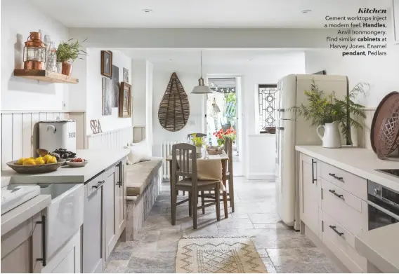  ??  ?? Kitchen
Cement worktops inject a modern feel. Handles,
Anvil Ironmonger­y. Find similar cabinets at Harvey Jones. Enamel pendant, Pedlars