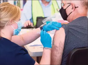  ?? Christian Abraham / Hearst Connecticu­t Media file photo ?? Mallory Bates, a nurse at Norwalk Hospital, administer­s a COVID-19 vaccine to Salvatore Rigillo on March 20.