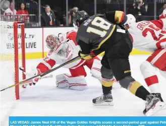  ?? — AFP ?? LAS VEGAS: James Neal #18 of the Vegas Golden Knights scores a second-period goal against Petr Mrazek #34 of the Detroit Red Wings during their game at T-Mobile Arena Friday.
