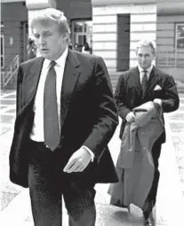  ?? DANIEL HULSHIZER/AP ?? Roger Stone follows Donald Trump out of a federal courthouse in Newark, N.J., in 1999. Stone’s ties to now-President Trump date back four decades, longer than any of the president’s other advisers.