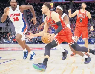  ?? GREGORY SHAMUS/GETTY ?? Zach LaVine drives around Isaiah Stewart of the Detroit Pistons on Wednesday. The Bulls defeated the Pistons to start the 2021-22 season.