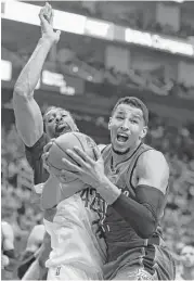  ??  ?? The Thunder’s Andre Roberson, right, grabs one of his eight rebounds in front of Rockets center Nene.