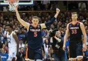  ?? Ben McKeown / AP ?? Virginia’s Kyle Guy (5) and Jack Salt (33) walk off the court following their team’s victory against Duke.