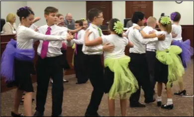  ??  ?? Students from Foothills Elementary School show off the dance skills learned in their school’s ballroom dance program during a meeting of the Nebo School District Board of Education.