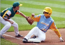  ?? GENE J. PUSKAR - THE ASSOCIATED PRESS ?? Honolulu, Hawaii’s Ryan Keanu (27) slides safely into third base as Hastings, Neb.’s Benjamin Wibbels waits for a late throw from right field during the first inning of a baseball game at the Little League World Series in South Williamspo­rt, Pa., Sunday, Aug. 22, 2021.