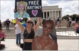  ?? JOSE LUIS MAGAN — THE ASSOCIATED PRESS FILE ?? Maggie Howell, a supporter of pop star Britney Spears, protests next to a Britney Spears cardboard cutout during a rally at the Lincoln Memorial in Washington.