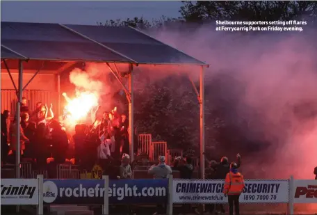  ??  ?? Shelbourne supporters setting off flares at Ferrycarri­g Park on Friday evening.