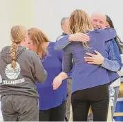 ?? Paul Augeri/For Hearst Connecticu­t Media ?? East Hampton head coach Shaun Russell hugs assistant Allyson Smith after the Bellringer­s secured their fourth straight Shoreline title on Saturday.