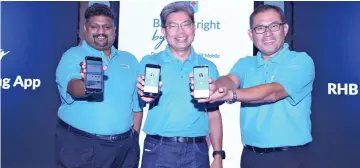  ??  ?? (From left) RHB group chief operations officer Rohan Krishnalin­gam, Khairussal­eh and acting head of group retail banking Nazri Othman at the launch of the new RHB Mobile Banking App yesterday.