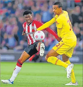  ?? AFP ?? Southampto­n's Ghanaian defender Mohammed Salisu (L) fights for the ball with Liverpool's Japanese midfielder Takumi Minamino during the English Premier League match.