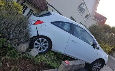  ??  ?? Chelsea Endacott’s Vauxhall Corsa was left teetering on a low wall after careering down a hill