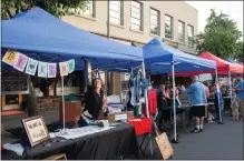  ?? ?? Left: Artist Bonnie Parkin sets up her artist booth Thursday for the Chico Artist’s Block featured during the Thursday Night Market in Chico. Below:
Rep. Doug LaMalfa, right, hands a congressio­nal recognitio­n of Chico’s
150 year celebratio­n to Mayor Andrew Coolidge Thursday at the City Plaza stage in Chico.